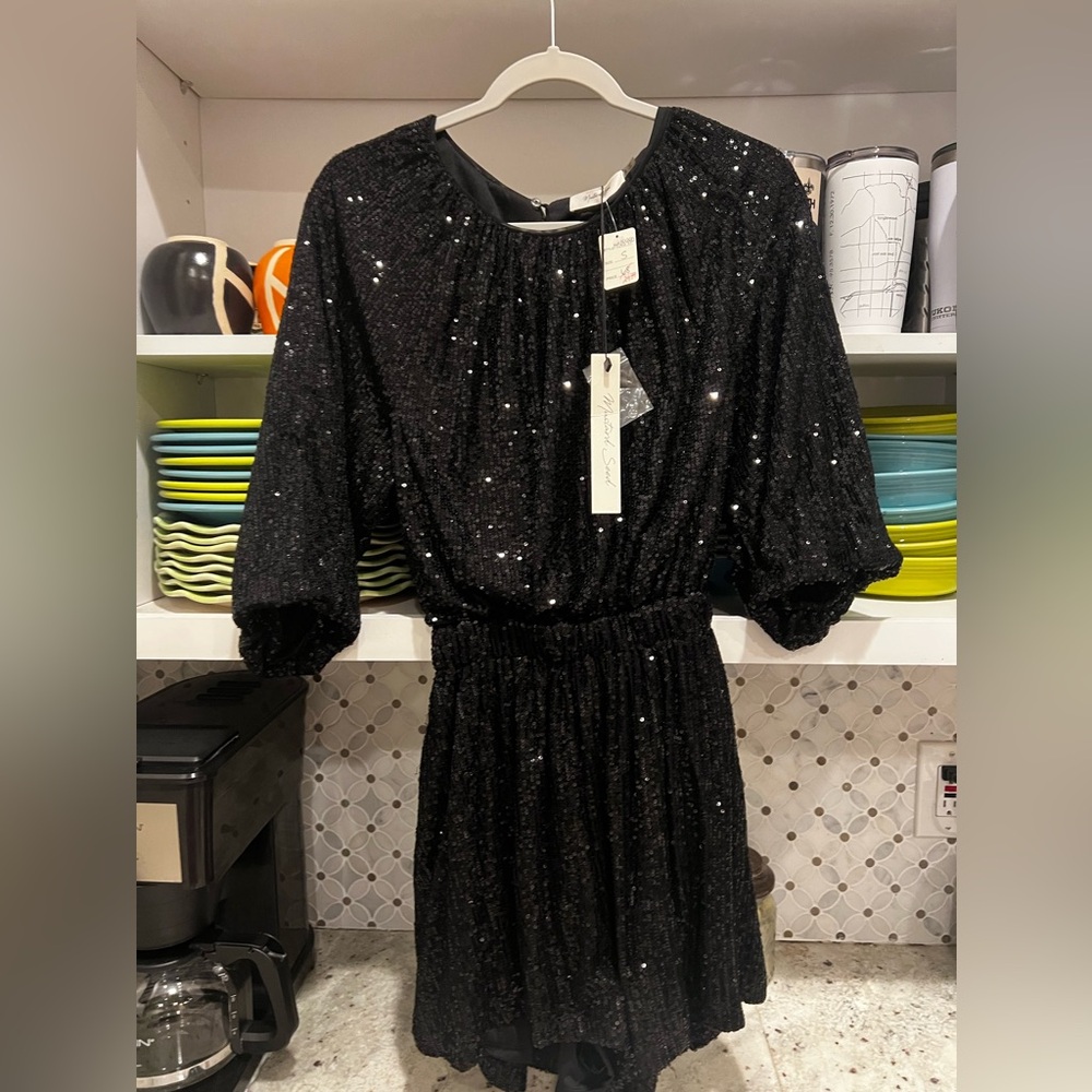 Black lined sequin short romper, open in back.